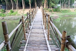 a bamboo bridge on river for people crossing