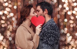 boyfriend and girlfriend kisisng behind