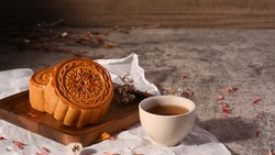 Mid autumn festival mooncake and and green tea on stone table