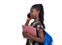 young female student wearing backpack standing on white background talking on the phone while holding a document.
