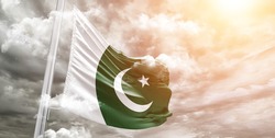 Pakistan national flag cloth fabric waving on beautiful grey sky.