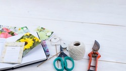 Spring garden preparation concept. Top view of seed packets, planner and gardening tools