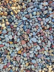 Pebbles or gravel textures on the ground. Texture of natural rubble. Stones, crushed stone building material. The colored stones on the shore. Stone wall. Zen meditation of rock garden concept