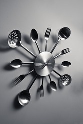 Kitchen abstract clock witch spoon and fork. Dramatic light used