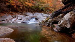 Waterfall and water vortex of autumn Baemsagol Valley at Mt Jirisan near Namwon, Korea.
