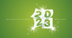 We wish you a Happy New Year 2023 greeting card design template with light sparkle firework on lucky green background. New Year 2023 start concept