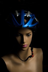 blue bicycle sports helmet on a mannequin with a female face for dummy protection