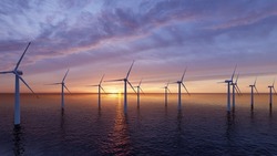 Offshore Wind Turbines Farm at sunset.