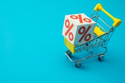 Shopping in department store, modern trade, hypermarket in lifestyle sale promotion season concept. Percentage(%) paper box in supermarket trolley on blue background. Shopaholic love 50% off promotion