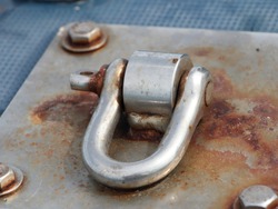 Metal made with stainless steel for tying up a rusted metal boat.