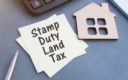 SDLT - Stamp Duty Land Tax write on a card on office desk.