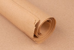 Brown kraft wrapping paper roll. Eco-friendly kraft paper sheets for wrapping goods or gifts. Sustainable packaging concept