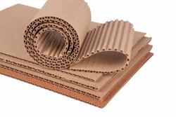 Corrugated cardboard layer pads and flexible singleface corrugated paper in roll isolated on white. Environmentally friendly paper packaging. Packaging for safe transportation