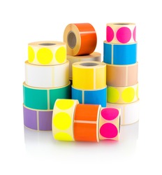 Colored label rolls isolated on white background with shadow reflection. Color reels of labels for printers. Labels for direct thermal or thermal transfer printing. Square and circle labels background