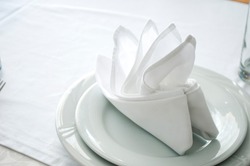Napkins in the shape of a ship for decoration at a wedding

