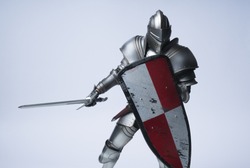 Knight with sword and red checkered shield on isolated background