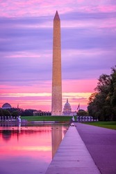View of Washington Monument and United States Capitol fromLincoln Memorial Reflecting Pool at sunrise in Washington DC, USA.