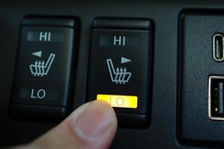 A switch to activate heated seats in car seats.