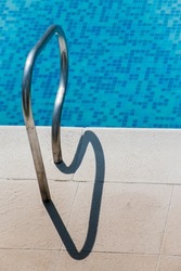 Detail of a blue swimmingpool in sunny day at summer