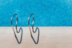 Detail of a blue swimmingpool in sunny day at summer