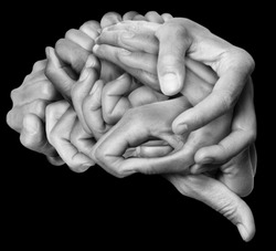 Human brain made with hands, different hands are wrapped together to form a brain. Black background.