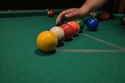 the player places the balls on the billiard table. a game of billiards competition.