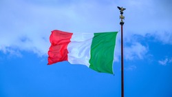 Italian flag waving over a cloudy sky on the background. Symbolic image of the Italian National Day and Republic Day on June 2nd 2020.
