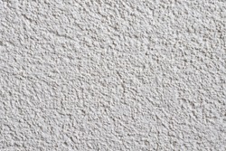 White structural facade plaster. Acrylic plaster structure. Lamb style plaster with small granules