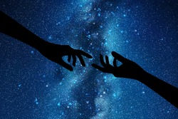 Reaching hands. Hand gesture silhouette. Night starry sky, Milky Way