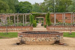 water feature and pathway through an attractive walled garden	