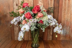Beautiful bouquet of arranged roses, orchids, and filler leavesto create an expressive sentiment of flowers.