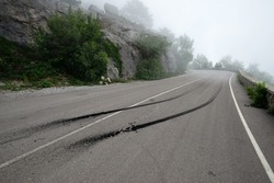 Traces of burnt rubber after the start of the car on a foggy mountain road.