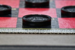 Black checkers on a checker board