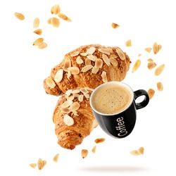 Fresh baked almond  breakfast croissants  with nuts flakes crumbs and black cup hot espresso coffee flying isolated on white background. Two croissants and cup falling. Pastry shop or cafe card.