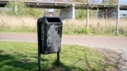 a bin with graffiti on it 