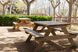 Place in the park for picnic and relaxation. Wooden table and benches.