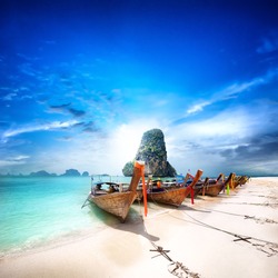 Travel to Thailand exotic destination landscape. Paradise island beach with boats. Beauty of thai tourism