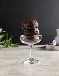 Chocolate chip scone in wine glass  on cement background