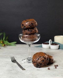 Chocolate chip scone in wine glass  on cement background