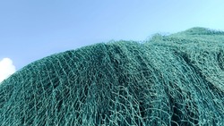 Mesh Mountains: Exploring the Art of Stacking Fishing Nets