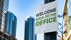Welcome back to the office Worn Sign in Downtown city setting
