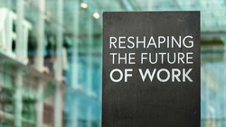 Reshaping the future of work on a city-center sign in front of a modern office building	
