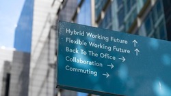 Working future choices on a city-center sign in front of a modern office building	
