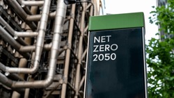 Net Zero 2050 on a sign in front of an Industrial building