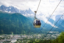 Cable car traveling over Chamonix in Mont Blanc area in France with the mountain panoramic view. 
