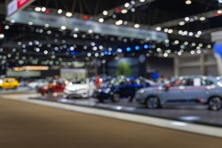 Abstract blurred image of people in cars exhibition show including activities and innovative automotive exhibitions 