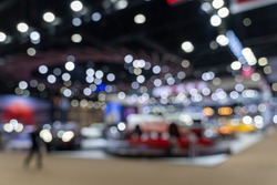 Abstract blurred image of people in cars exhibition show including activities and innovative automotive exhibitions. Blurred for background concept.