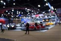 Abstract blurred image of people in cars exhibition show including activities and innovative automotive exhibitions at display. Blurred for background concept.