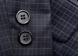 Sleeve with buttons on the men's check suit. Men's suit. Part, item of clothing