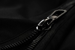 Black lock with a zipper on clothes close-up. Lock.